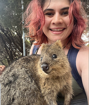 girl in park cuddling animal